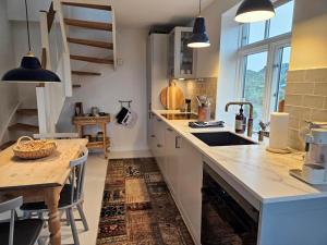 a kitchen with a wooden counter top and a table at FAN074-Fano-Kystvejen-13 in Fanø