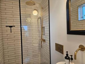 a bathroom with a shower with a toilet and a sink at FAN074-Fano-Kystvejen-13 in Fanø
