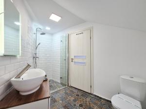 a bathroom with a sink and a toilet and a shower at Gaste Haus Ober in Braşov +98 photos