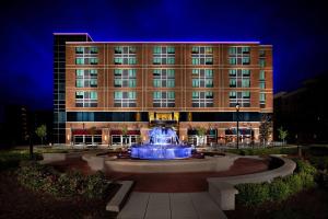 a building with a fountain in front of a building at The Hotel at Arundel Preserve in Hanover