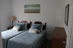 a small bedroom with two beds and a table at Wood Duck Cottage in Cavendish