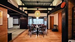 a dining room with a table and chairs at 古民家宿 孫八 - Mago8 in Maibara