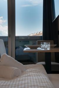 a room with a table and a window with a view at myQuartier Urban Residences in Innsbruck
