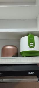 a green and white toaster sitting on top of a keyboard at Luxe Cozy Haven in Cybersouth in Kampung Dengkil