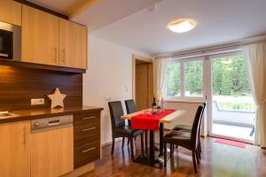 a kitchen and dining room with a table and chairs at Apart Praxmarer in Sölden