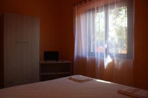 Postel nebo postele na pokoji v ubytování B&B La Cantoniera