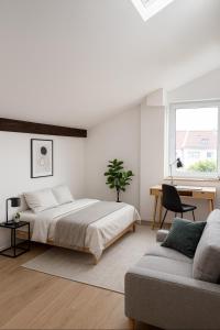 a bedroom with a bed and a desk and a couch at WG-Zimmer-Erstbezug nach Sanierung -Vollmöbliert in Taunusstein