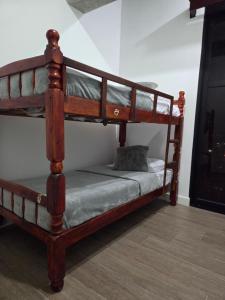 a wooden bunk bed in a room at Aparhotel Monch in Guatemala