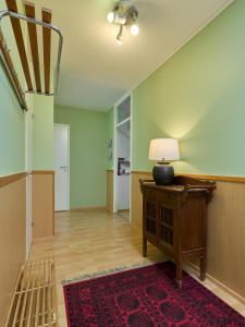 an empty hallway with a table and a lamp on it at Spacious 3-Room Flat in Martinlaakso in Vantaa