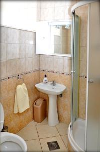 a bathroom with a sink and a shower at Apartments Lumbarda in Lumbarda