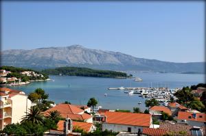 a view of a city with boats in a harbor at Apartments Lumbarda in Lumbarda