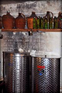 two metal tanks in a kitchen with bottles on a shelf at Apartments Lumbarda in Lumbarda