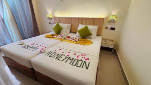 a bedroom with a bed with a happy anniversary sign on it at Dream Inn at Thulusdhoo in Thulusdhoo