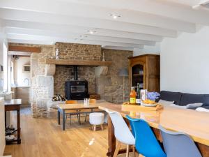 a kitchen and living room with a stone wall at Maisons de la Clarté - Cottage Mer in Perros-Guirec +17 photos