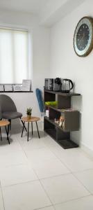 a living room with a clock and a table at Pensión La Marina in Alicante +32 photos