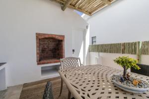 a dining room with a table and a fireplace at Milky Way Holiday Home in Paternoster +12 photos