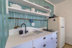 a kitchen with a sink and a refrigerator at Milky Way Holiday Home in Paternoster