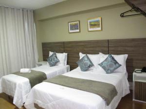 מיטה או מיטות בחדר ב-Hotel & Pousada Princesa Isabel Rua Teresa