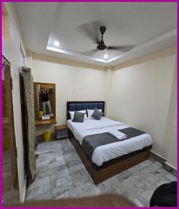 a bedroom with a bed and a ceiling at V - PREMIUM R - GH - Varanasi - Free Wi-Fi & Parking - Near The Holy Kashi Vishwanath Temple! in Varanasi +8 photos