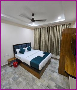 a bedroom with a bed and a television in it at V - PREMIUM R - GH - Varanasi - Free Wi-Fi & Parking - Near The Holy Kashi Vishwanath Temple! in Varanasi