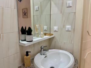 a bathroom with a sink and a mirror at La dimora di Traiano in Terracina +9 photos