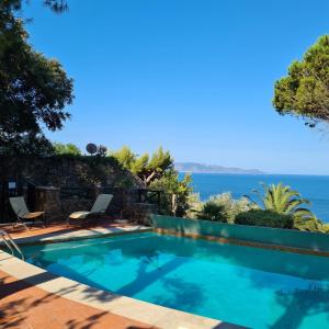 a swimming pool with a view of the ocean at Argentarola in Porto Santo Stefano,Pool and Sea View in Porto Santo Stefano