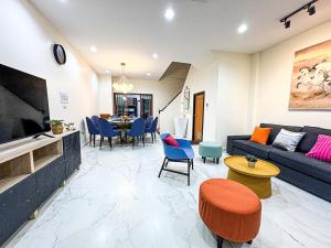 a living room with a couch and a table at SPACIOUS, 3 mins walking to BTS Phra Khanong & Near Thonglo, Em District, Terminal 21, MAX 20 People in Bangkok