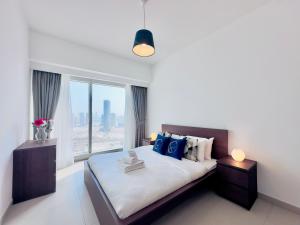 a bedroom with a bed with a large window at Urban Oasis 1BR Apartment in Gate Towers in Abu Dhabi +52 photos
