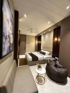 a hotel room with a bed and a couch at Hotel Casa Inn in Indore