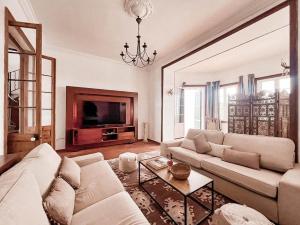 a living room with a couch and a tv at Son Pere - Romantic Hilltop Stay in Ferreries