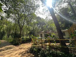 a fence in front of a house in the woods at Pookie stay athirapilly in Athirappilly