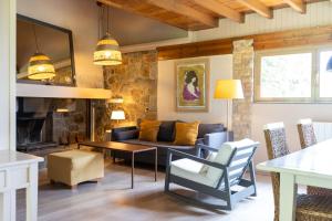 a living room with a couch and a table at Les Planes de Viladrau in Viladrau