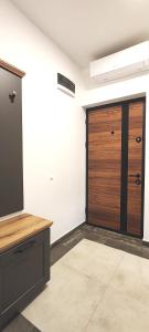 a garage with a wooden door in a room at MJ apartments - Villa Bulik in Vršac