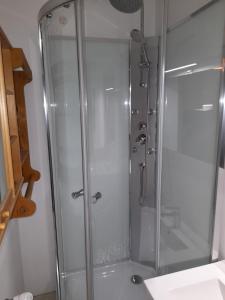 a shower with a glass door in a bathroom at Studio en centre village St Gervais in Saint-Gervais-les-Bains