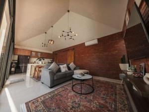 a living room with a couch and a table at Kubu Tebo Villa Uluwatu in Uluwatu