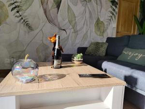 a table with a bottle of wine on top of it at Bel Horizon in Saint-Jean-Froidmentel