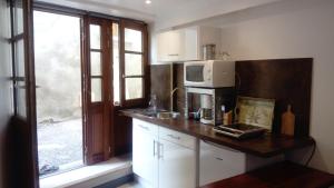 a kitchen with a counter with a microwave and a window at Studio centre Volonne in Volonne