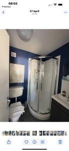 a bathroom with a shower and a toilet and a sink at The Harnser in Stalham +26 photos