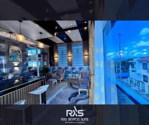a room with a bar and a view of a balcony at RXS SkyPod #3 Suite Condotel - Roxas City in Roxas City