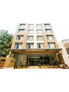 a tall building with a store in front of it at Hotel The Westinn in Varanasi