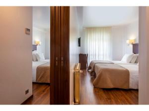 Postel nebo postele na pokoji v ubytování Hotel Miramar - São Pedro de Moel