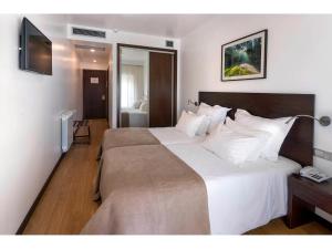 Postel nebo postele na pokoji v ubytování Hotel Miramar - São Pedro de Moel