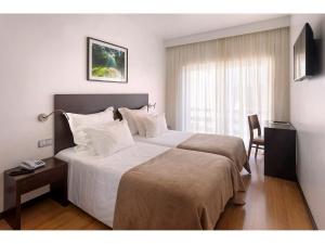 Postel nebo postele na pokoji v ubytování Hotel Miramar - São Pedro de Moel