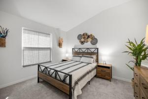 a bedroom with a bed and a window at Cozy 2BR With Golfcart 5 Mins to Eastport Sq in Wildwood +21 photos