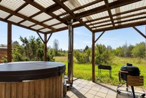 a covered patio with a grill and a grill at Kadaksalu with sauna hinnas in Ruu +17 photos