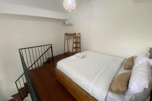 a small room with a bed and a ladder at D'Muarra Studio Villa in Cemagi