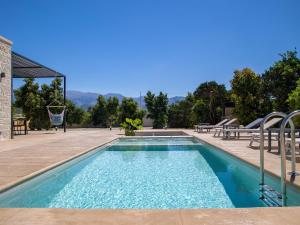 a swimming pool with a picnic table and benches around it at PanStel - Villa Solene with private pool in Ayiá