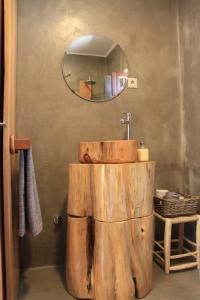 a bathroom with a wooden sink and a mirror at Casa do Páteo in Aldeia do Meco +32 photos