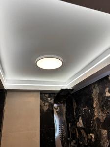 a ceiling with a light in a room at Cretan stars villas in Limín Khersonísou +65 photos