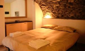 a bedroom with a bed with two towels on it at Casa Valtournenche in Valtournenche
